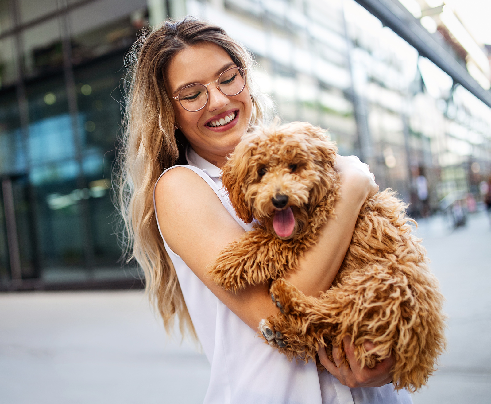 beauty-woman-with-her-dog-playing-outdoors-LN2XF4U.jpg